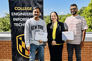 Rishav Gupta and ASM Mobarak Hossain receiving the COEIT Computing for Social Good Award from Jeanne M. van Briesen, dean of the College of Engineering and Information Technology.